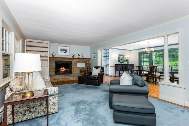 66 Saunders Dr, Wilton, CT 06897 - living room with a chandelier, crown molding, a fireplace, and wood finished floors