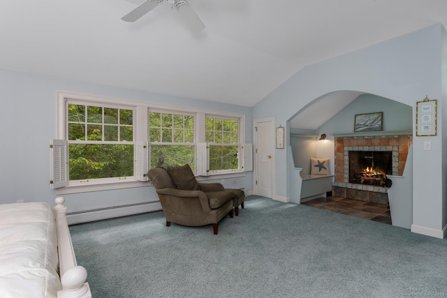 66 Saunders Dr, Wilton, CT 06897 - carpeted living room with a baseboard radiator, a ceiling fan, lofted ceiling, a tiled fireplace, and arched walkways