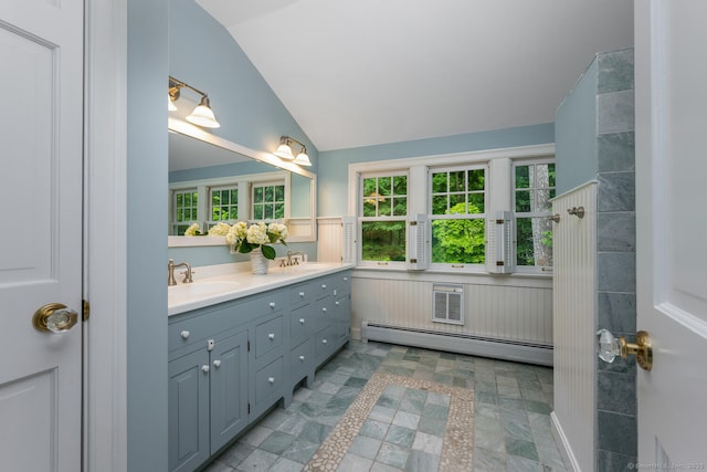 66 Saunders Dr, Wilton, CT 06897 - bathroom featuring a baseboard radiator, double vanity, vaulted ceiling, and plenty of natural light