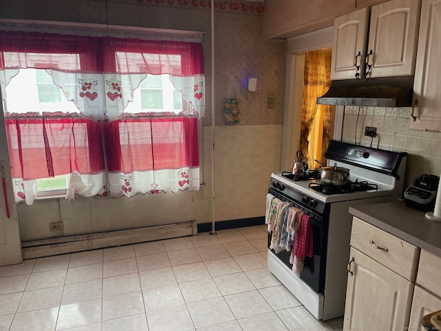 190 Holcomb St, Hartford, CT 06112 - kitchen featuring range with gas cooktop, under cabinet range hood, wallpapered walls, baseboard heating, and dark countertops