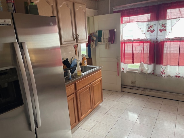 190 Holcomb St, Hartford, CT 06112 - kitchen featuring stainless steel refrigerator with ice dispenser, a sink, dark countertops, brown cabinets, and light tile patterned floors