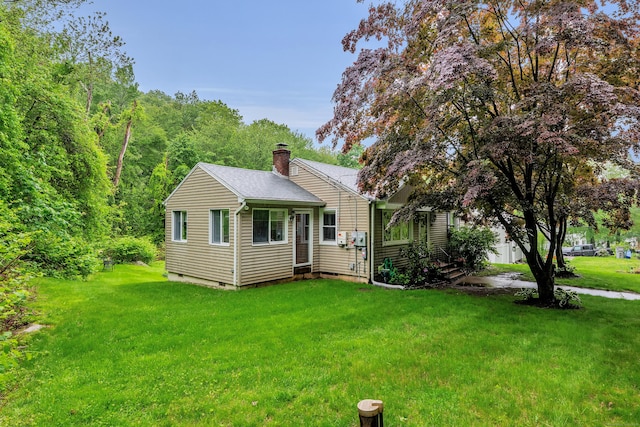 314 Old Wolcott Rd, Bristol, CT 06010 - view of home's exterior featuring a chimney, a yard, a shingled roof, and crawl space