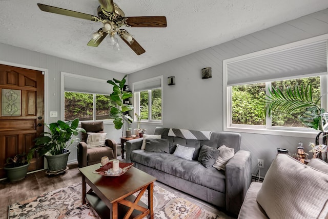 314 Old Wolcott Rd, Bristol, CT 06010 - living room with wood finished floors, a ceiling fan, a textured ceiling, and wooden walls