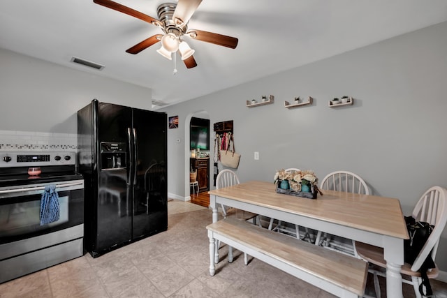 314 Old Wolcott Rd, Bristol, CT 06010 - kitchen with stainless steel range with electric stovetop, black refrigerator with ice dispenser, arched walkways, and a ceiling fan