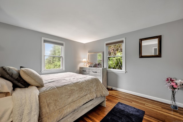 314 Old Wolcott Rd, Bristol, CT 06010 - bedroom with multiple windows, baseboards, and wood finished floors