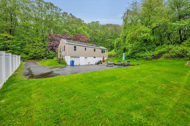 314 Old Wolcott Rd, Bristol, CT 06010 - view of yard with a garage, a forest view, and asphalt driveway