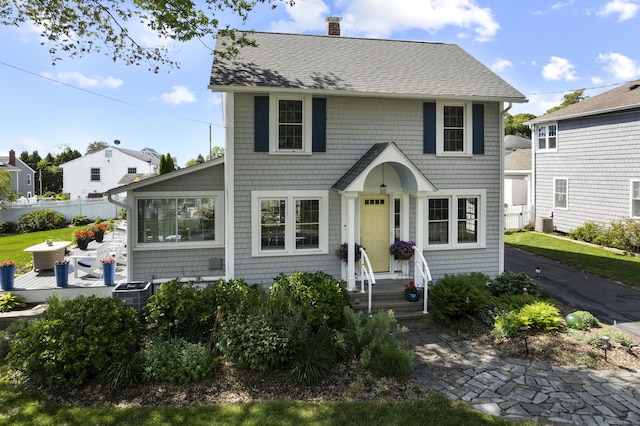 15 Attawan Ave, East Lyme, CT 06357 - view of front facade with a chimney and a shingled roof
