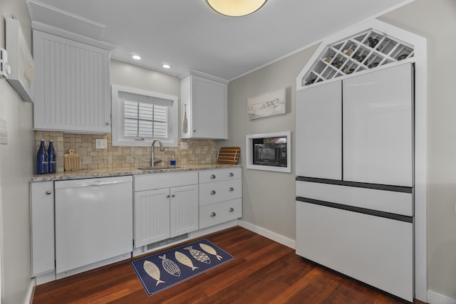 15 Attawan Ave, East Lyme, CT 06357 - kitchen featuring white dishwasher, a sink, black microwave, dark wood-type flooring, and decorative backsplash