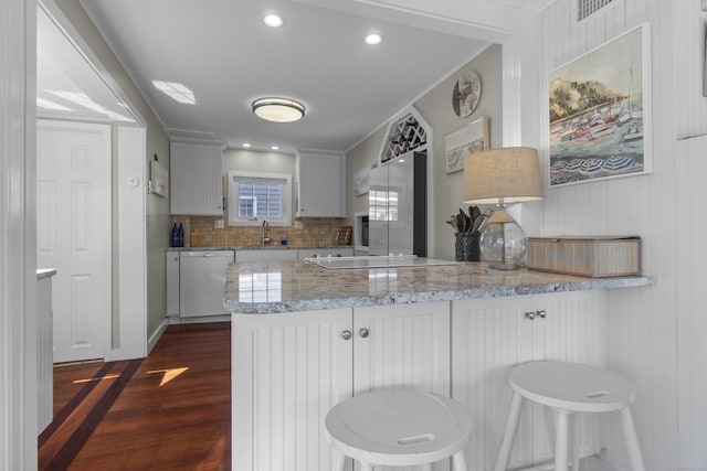 15 Attawan Ave, East Lyme, CT 06357 - kitchen with dishwasher, a peninsula, dark wood finished floors, tasteful backsplash, and a sink