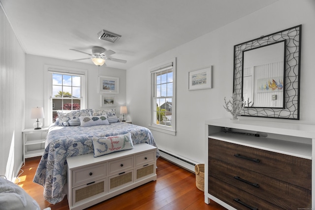 15 Attawan Ave, East Lyme, CT 06357 - bedroom featuring a baseboard heating unit, multiple windows, wood finished floors, and ceiling fan