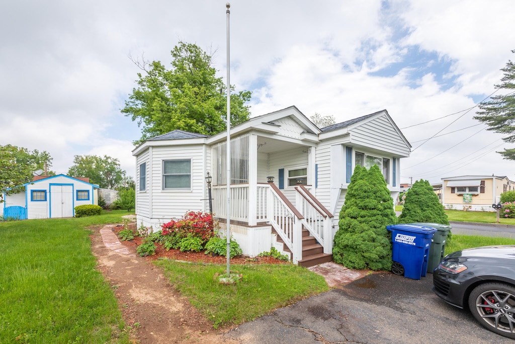 2 Oak Rd, Southington, CT 06489 - view of front of home featuring a front yard, a storage shed, and an outdoor structure