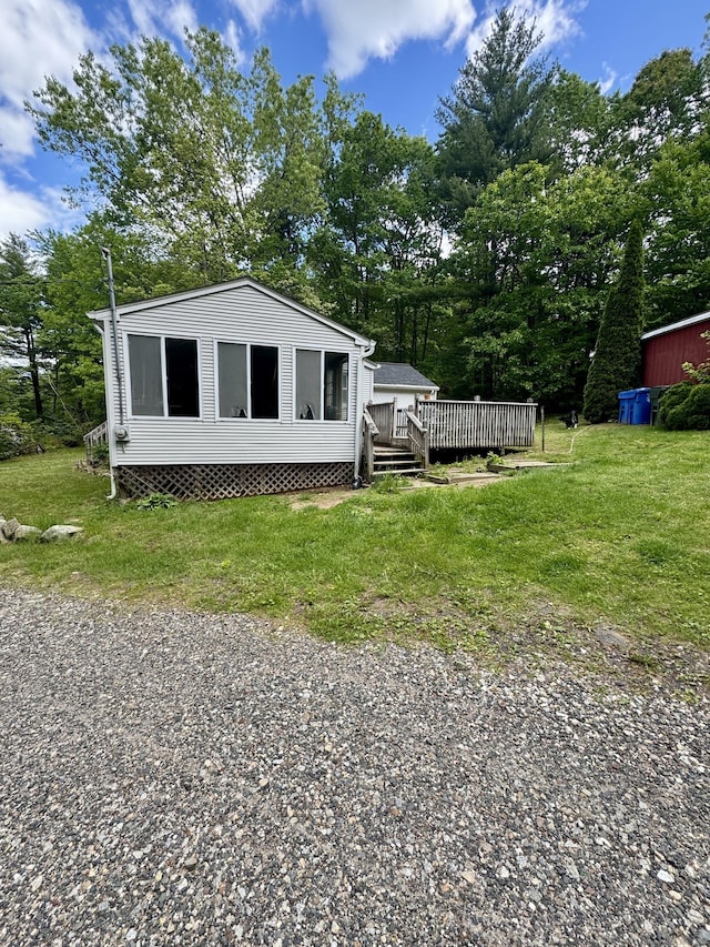 616 Crystal Lake Rd, Tolland, CT 06084 - view of front of house featuring a deck, a front yard, and view of scattered trees