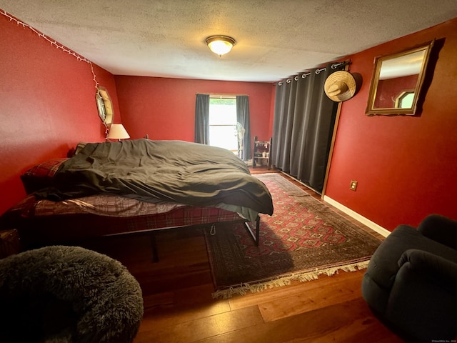 616 Crystal Lake Rd, Tolland, CT 06084 - bedroom with a textured ceiling, wood finished floors, and baseboards