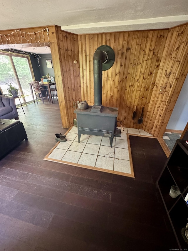 616 Crystal Lake Rd, Tolland, CT 06084 - living room with wood walls, a wood stove, hardwood / wood-style flooring, and a textured ceiling