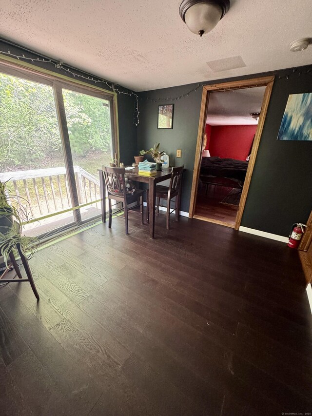 616 Crystal Lake Rd, Tolland, CT 06084 - dining space with a textured ceiling, wood finished floors, and baseboards
