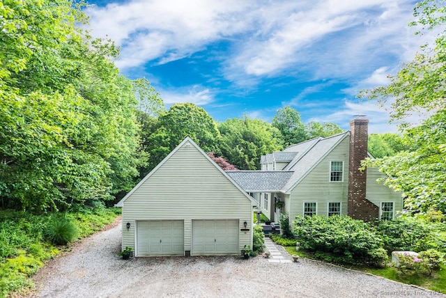 28 Hudson Ln, Essex, CT 06426 - view of front of property featuring a chimney, driveway, and roof with shingles