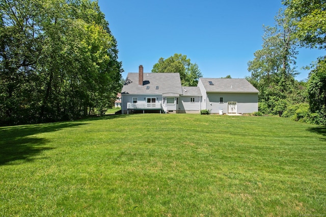 10 Colonial Dr, Clinton, CT 06413 - back of house with a lawn, a wooden deck, and a chimney
