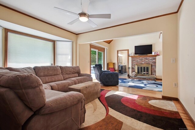 10 Colonial Dr, Clinton, CT 06413 - living room featuring wood finished floors, a ceiling fan, a fireplace, and crown molding