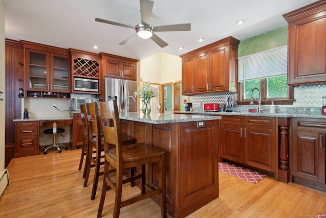 10 Colonial Dr, Clinton, CT 06413 - kitchen with stainless steel appliances, decorative backsplash, light wood-type flooring, a kitchen bar, and recessed lighting