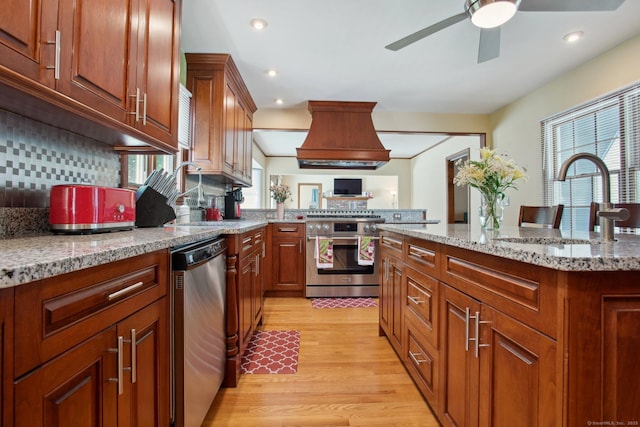 10 Colonial Dr, Clinton, CT 06413 - kitchen featuring appliances with stainless steel finishes, custom exhaust hood, a sink, a ceiling fan, and light wood-style flooring