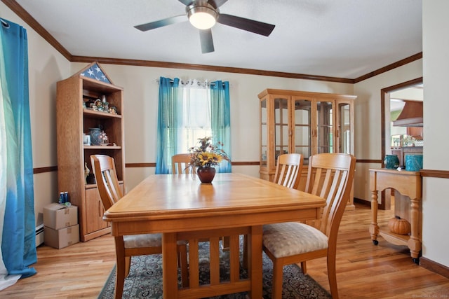 10 Colonial Dr, Clinton, CT 06413 - dining area featuring light wood-style flooring, ceiling fan, crown molding, baseboards, and a baseboard radiator