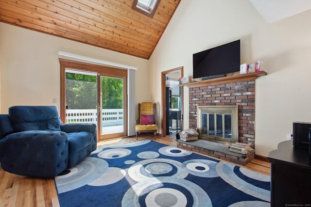 10 Colonial Dr, Clinton, CT 06413 - living room featuring wood finished floors, a fireplace, high vaulted ceiling, wooden ceiling, and a skylight