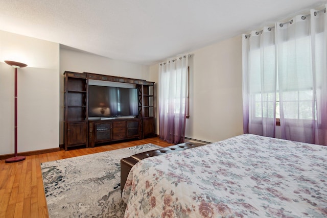 10 Colonial Dr, Clinton, CT 06413 - bedroom featuring wood finished floors, baseboards, and a baseboard heating unit