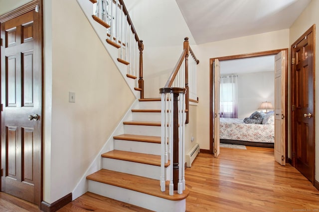 10 Colonial Dr, Clinton, CT 06413 - stairs featuring wood finished floors, baseboard heating, and baseboards