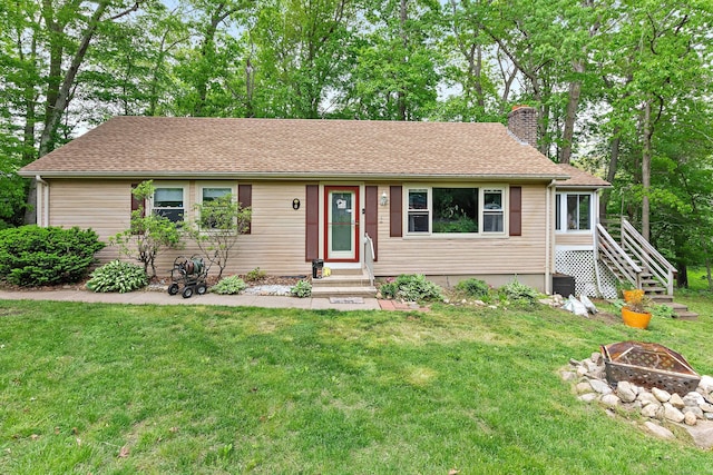 8 Sycamore Rd, East Lyme, CT 06357 - single story home with an outdoor fire pit, a chimney, a front lawn, and roof with shingles