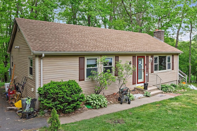 8 Sycamore Rd, East Lyme, CT 06357 - view of front of house with a chimney, a shingled roof, and a front lawn