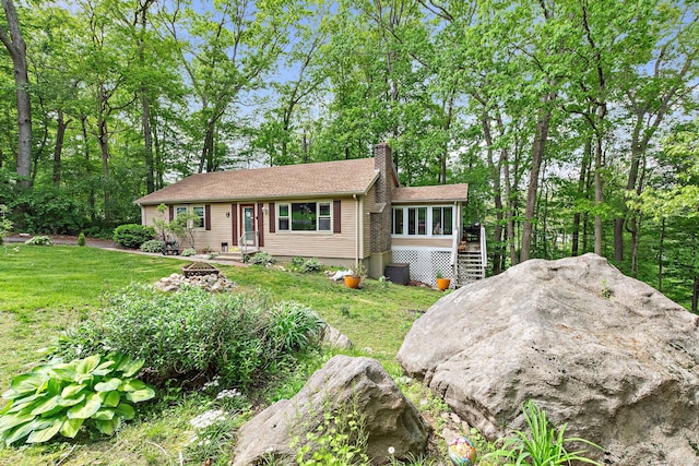 8 Sycamore Rd, East Lyme, CT 06357 - view of front of home with a chimney, stairway, an outdoor fire pit, a front yard, and central air condition unit