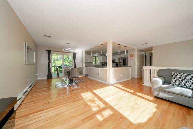 56 Buena Vista Dr, East Hartford, CT 06118 - living room with baseboard heating, light wood-style floors, and baseboards