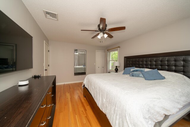 56 Buena Vista Dr, East Hartford, CT 06118 - bedroom with light wood-type flooring, baseboards, a ceiling fan, and a textured ceiling