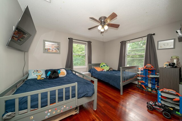 56 Buena Vista Dr, East Hartford, CT 06118 - bedroom featuring hardwood / wood-style flooring, multiple windows, a textured ceiling, and ceiling fan