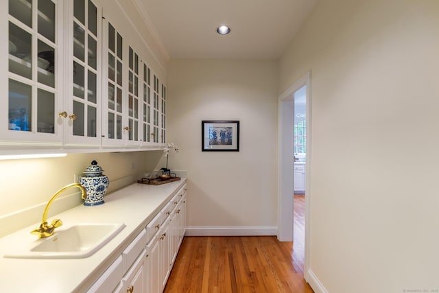 14 Fernhurst, Farmington, CT 06032 - bar area featuring light wood-style flooring, a sink, baseboards, and recessed lighting