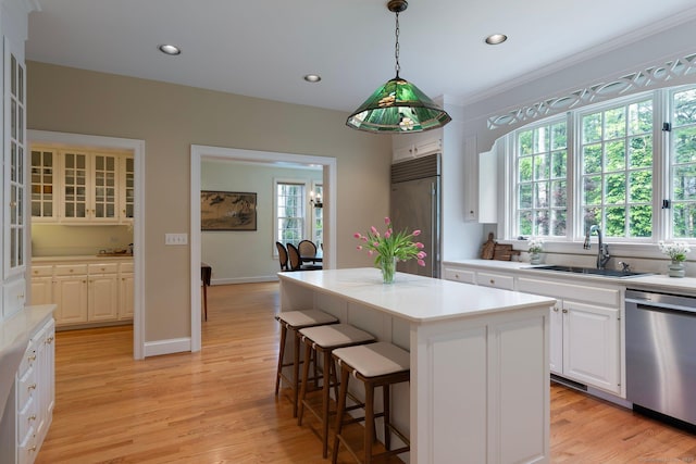 14 Fernhurst, Farmington, CT 06032 - kitchen with dishwasher, built in fridge, a sink, light wood-style floors, and a center island