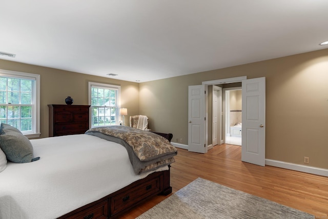 14 Fernhurst, Farmington, CT 06032 - bedroom with baseboards, multiple windows, and light wood-style floors