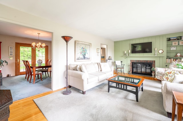 5 Old Bethel Rd, Newtown, CT 06470 - living area with a chandelier, wood finished floors, and a fireplace