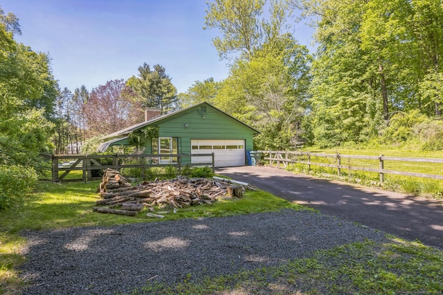 200 Willow St, Hamden, CT 06518 - view of front facade with a chimney, a garage, and asphalt driveway