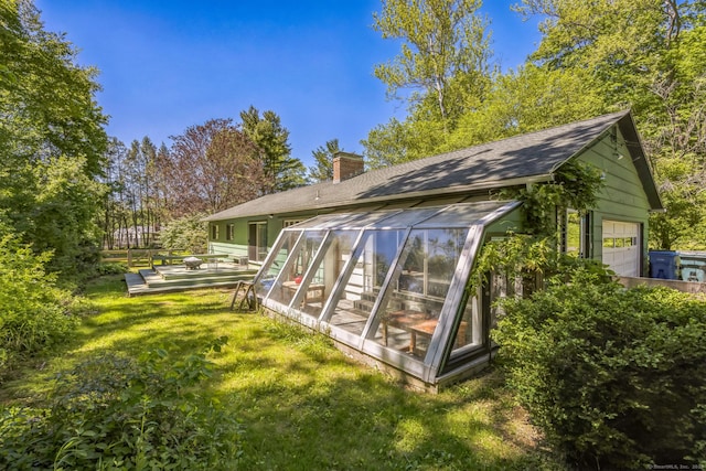200 Willow St, Hamden, CT 06518 - rear view of house with a chimney, roof with shingles, a lawn, a sunroom, and a garage