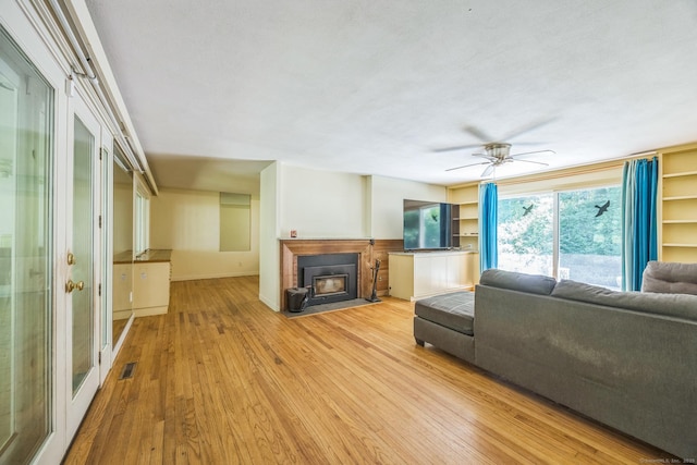 200 Willow St, Hamden, CT 06518 - living room featuring wood finished floors, a fireplace with flush hearth, and a ceiling fan