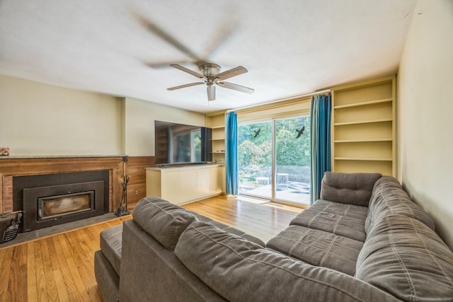 200 Willow St, Hamden, CT 06518 - living area featuring a fireplace with flush hearth, a ceiling fan, wood finished floors, and wainscoting