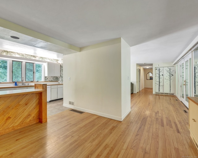 200 Willow St, Hamden, CT 06518 - kitchen featuring light wood finished floors, light countertops, a sink, and baseboards