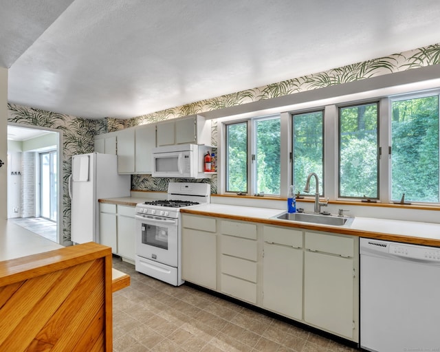 200 Willow St, Hamden, CT 06518 - kitchen featuring white appliances, a sink, light countertops, and wallpapered walls