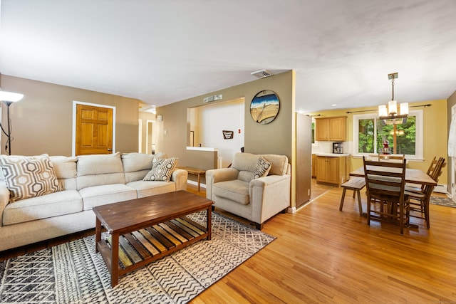 55 Andrasko Rd, Beacon Falls, CT 06403 - living room featuring light wood-style floors and a chandelier