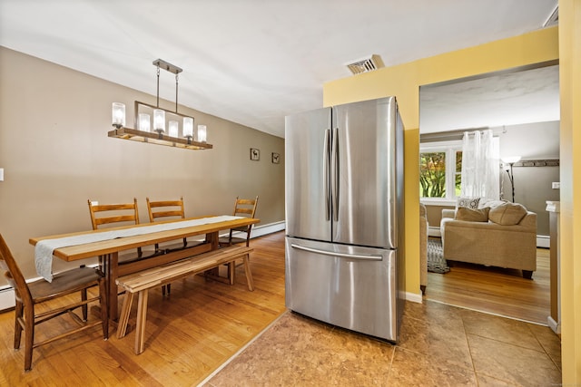 55 Andrasko Rd, Beacon Falls, CT 06403 - dining area with baseboards, light wood-style flooring, and baseboard heating