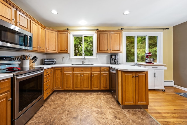 55 Andrasko Rd, Beacon Falls, CT 06403 - kitchen with appliances with stainless steel finishes, a sink, a baseboard radiator, light countertops, and a peninsula