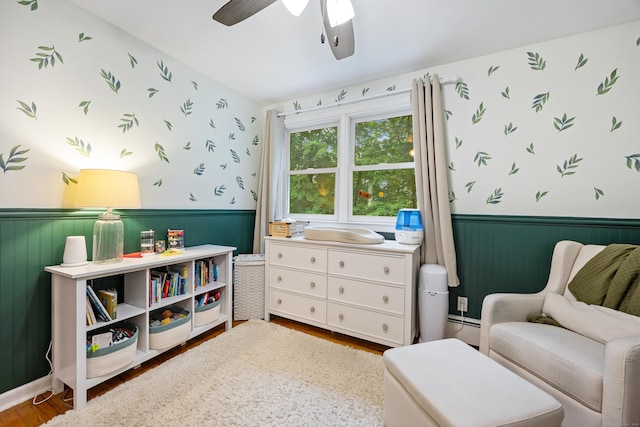 55 Andrasko Rd, Beacon Falls, CT 06403 - sitting room with a wainscoted wall, wood finished floors, a ceiling fan, wallpapered walls, and a baseboard radiator