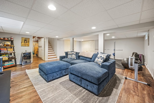 55 Andrasko Rd, Beacon Falls, CT 06403 - living area featuring stairs, wood finished floors, a paneled ceiling, baseboards, and beverage cooler