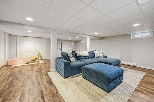 55 Andrasko Rd, Beacon Falls, CT 06403 - living room featuring baseboard heating, wood finished floors, a paneled ceiling, baseboards, and recessed lighting